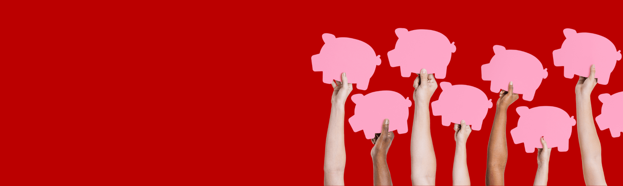 Hands holding pink cardboard pigs in the air on a red background